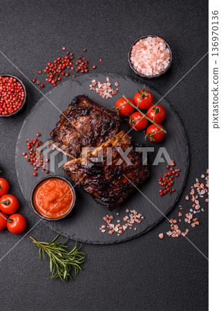 Grilled or barbecued pork or beef ribs, meat with red sauce for the dinner table. Grilled ribs Grilled or barbecued pork or beef ribs, meat with red sauce for the dinner table. Grilled ribs 136970136