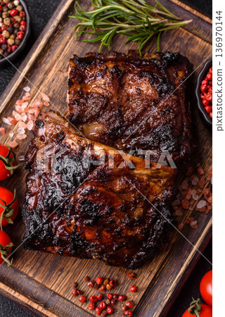 Grilled or barbecued pork or beef ribs, meat with red sauce for the dinner table. Grilled ribs 136970144