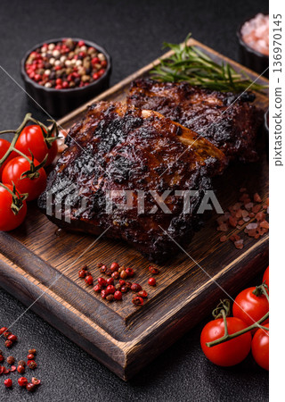 Grilled or barbecued pork or beef ribs, meat with red sauce for the dinner table. Grilled ribs 136970145