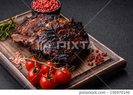 Grilled or barbecued pork or beef ribs, meat with red sauce for the dinner table. Grilled ribs Grilled or barbecued pork or beef ribs, meat with red sauce for the dinner table. Grilled ribs 136970146