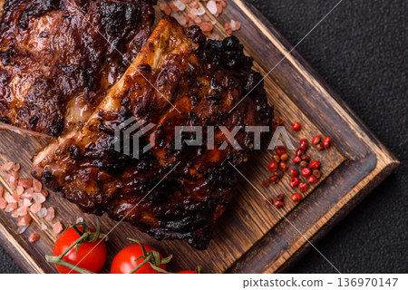 Grilled or barbecued pork or beef ribs, meat with red sauce for the dinner table. Grilled ribs Grilled or barbecued pork or beef ribs, meat with red sauce for the dinner table. Grilled ribs 136970147