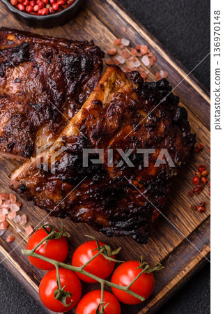Grilled or barbecued pork or beef ribs, meat with red sauce for the dinner table. Grilled ribs Grilled or barbecued pork or beef ribs, meat with red sauce for the dinner table. Grilled ribs 136970148