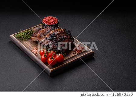 Grilled or barbecued pork or beef ribs, meat with red sauce for the dinner table. Grilled ribs Grilled or barbecued pork or beef ribs, meat with red sauce for the dinner table. Grilled ribs 136970150