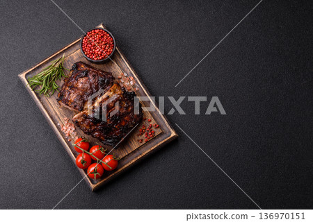 Grilled or barbecued pork or beef ribs, meat with red sauce for the dinner table. Grilled ribs Grilled or barbecued pork or beef ribs, meat with red sauce for the dinner table. Grilled ribs 136970151