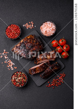 Grilled or barbecued pork or beef ribs, meat with red sauce for the dinner table. Grilled ribs Grilled or barbecued pork or beef ribs, meat with red sauce for the dinner table. Grilled ribs 136970168