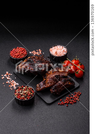 Grilled or barbecued pork or beef ribs, meat with red sauce for the dinner table. Grilled ribs 136970169