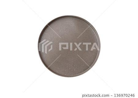 An empty round ceramic plate on a table, kitchenware. An empty plate 136970246
