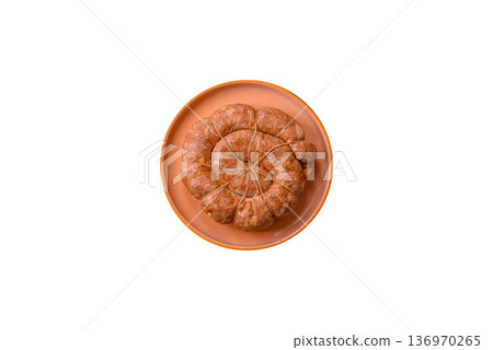 Grilled sausage in the shape of a spiral or snail, from chicken or pork. Spiral or snail sausage Grilled sausage in the shape of a spiral or snail, from chicken or pork. Spiral or snail sausage 136970265