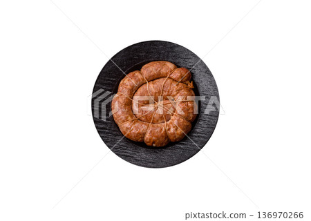 Grilled sausage in the shape of a spiral or snail, from chicken or pork. Spiral or snail sausage 136970266