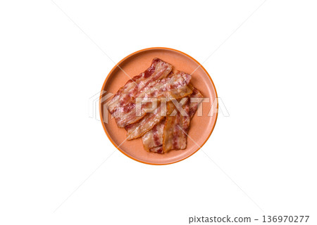 Fried smoked bacon slices, ham, jamon, or prosciutto strips for cooking. Fried bacon 136970277
