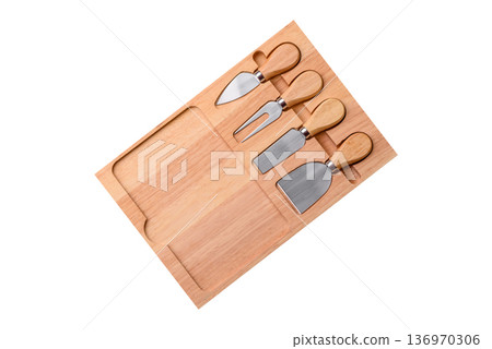 A set of cheese knives with a wooden cutting board, slicing tools. Cheese knives A set of cheese knives with a wooden cutting board, slicing tools. Cheese knives 136970306