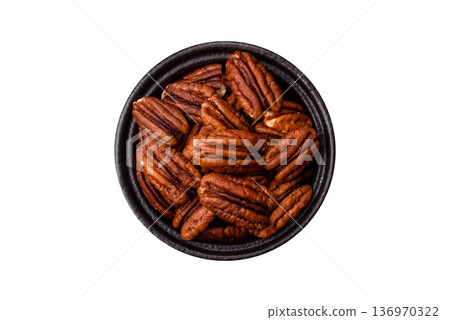 Peeled and roasted pecan nut as an ingredient for healthy food. Pecan nut as a food background 136970322