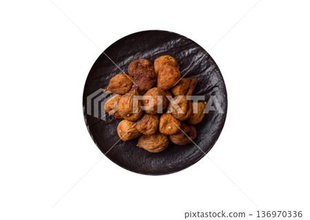Dried fig are a sweet, healthy fruit for vegans and vegetarians. Dried fig as a food background Dried fig are a sweet, healthy fruit for vegans and vegetarians. Dried fig as a food background 136970336