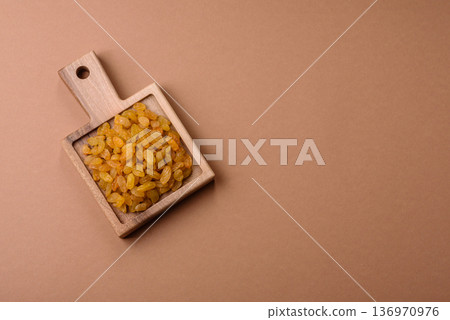 Sweet, dry, golden or yellow raisin made from grapes are a healthy, nutritious food. Golden raisins Sweet, dry, golden or yellow raisin made from grapes are a healthy, nutritious food. Golden raisins 136970976