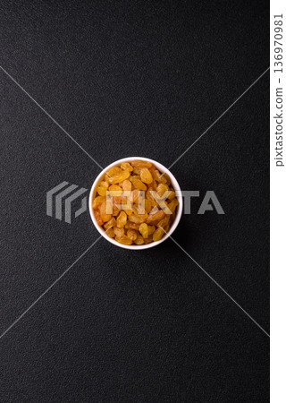 Sweet, dry, golden or yellow raisin made from grapes are a healthy, nutritious food. Golden raisins 136970981
