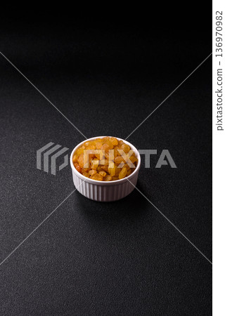 Sweet, dry, golden or yellow raisin made from grapes are a healthy, nutritious food. Golden raisins 136970982