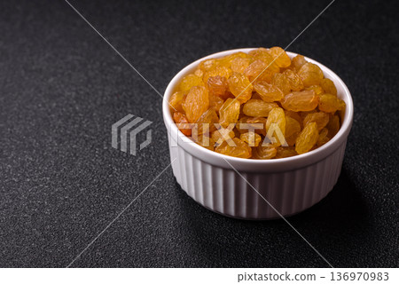 Sweet, dry, golden or yellow raisin made from grapes are a healthy, nutritious food. Golden raisins 136970983
