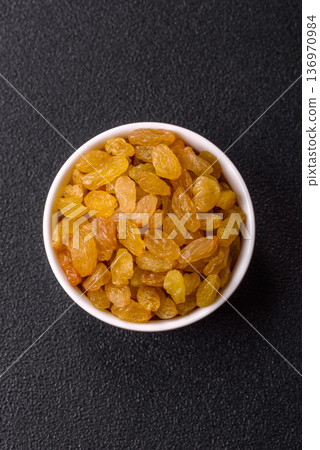 Sweet, dry, golden or yellow raisin made from grapes are a healthy, nutritious food. Golden raisins 136970984