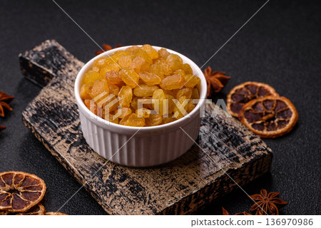 Sweet, dry, golden or yellow raisin made from grapes are a healthy, nutritious food. Golden raisins 136970986