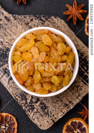 Sweet, dry, golden or yellow raisin made from grapes are a healthy, nutritious food. Golden raisins 136970988