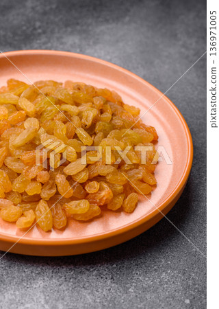 Sweet, dry, golden or yellow raisin made from grapes are a healthy, nutritious food. Golden raisins Sweet, dry, golden or yellow raisin made from grapes are a healthy, nutritious food. Golden raisins 136971005