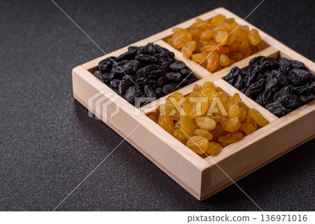 Sweet, dry, golden or yellow raisin made from grapes are a healthy, nutritious food. Golden raisins 136971016