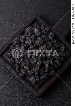 Sweet, dry black or blue raisins made from grapes are a healthy and nutritious food. Black raisins 136971034
