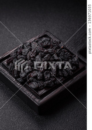 Sweet, dry black or blue raisins made from grapes are a healthy and nutritious food. Black raisins 136971035