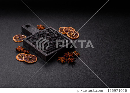 Sweet, dry black or blue raisins made from grapes are a healthy and nutritious food. Black raisins Sweet, dry black or blue raisins made from grapes are a healthy and nutritious food. Black raisins 136971036
