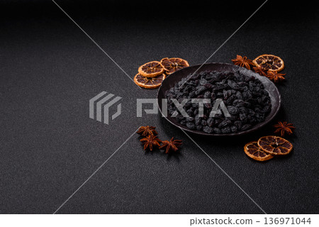 Sweet, dry black or blue raisins made from grapes are a healthy and nutritious food. Black raisins 136971044