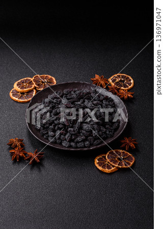 Sweet, dry black or blue raisins made from grapes are a healthy and nutritious food. Black raisins 136971047