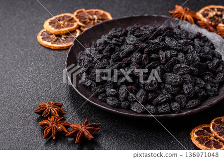 Sweet, dry black or blue raisins made from grapes are a healthy and nutritious food. Black raisins 136971048