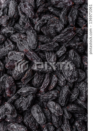 Sweet, dry black or blue raisins made from grapes are a healthy and nutritious food. Black raisins Sweet, dry black or blue raisins made from grapes are a healthy and nutritious food. Black raisins 136971061