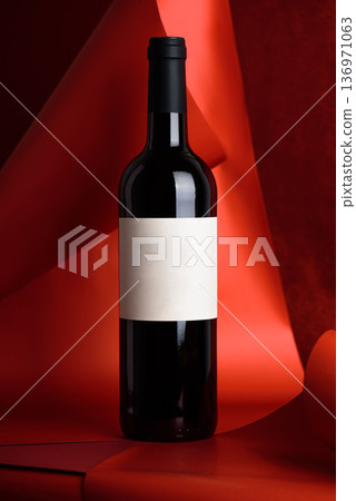 Red Wine Bottle on Red Background. Elegant Festive Still Life 136971063