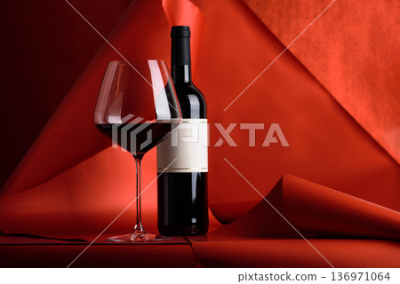 Red Wine Bottle and Glass on Red Background. Elegant Festive Still Life Red Wine Bottle and Glass on Red Background. Elegant Festive Still Life 136971064