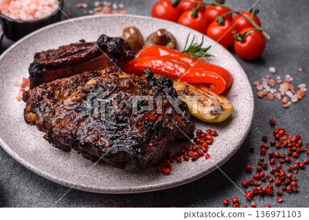 Grilled or barbecued pork or beef ribs, meat with red sauce for the dinner table. Grilled ribs 136971103