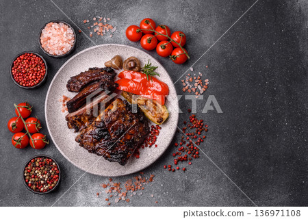 Grilled or barbecued pork or beef ribs, meat with red sauce for the dinner table. Grilled ribs Grilled or barbecued pork or beef ribs, meat with red sauce for the dinner table. Grilled ribs 136971108