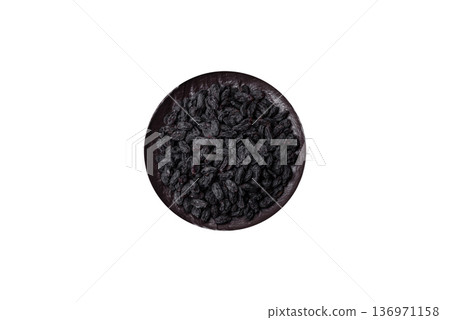Sweet, dry black or blue raisins made from grapes are a healthy and nutritious food. Black raisins Sweet, dry black or blue raisins made from grapes are a healthy and nutritious food. Black raisins 136971158