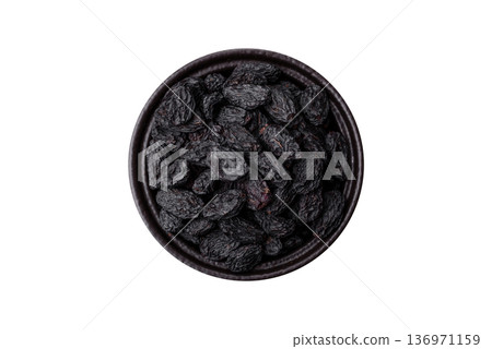 Sweet, dry black or blue raisins made from grapes are a healthy and nutritious food. Black raisins Sweet, dry black or blue raisins made from grapes are a healthy and nutritious food. Black raisins 136971159