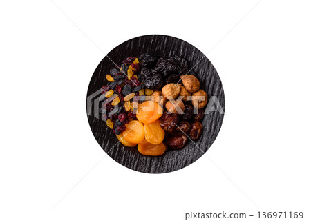 A variety of dried fruits, apricots, prunes, cranberries, raisins, figs. A dried fruit mix A variety of dried fruits, apricots, prunes, cranberries, raisins, figs. A dried fruit mix 136971169