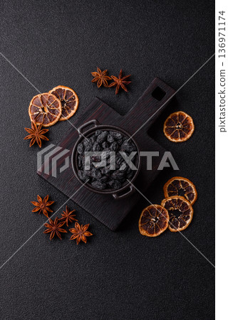 Sweet, dry black or blue raisins made from grapes are a healthy and nutritious food. Black raisins Sweet, dry black or blue raisins made from grapes are a healthy and nutritious food. Black raisins 136971174
