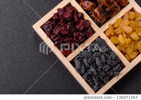 Dried fruits and berries, cranberries, dates, and raisins for a healthy diet. Dried berries and fruits Dried fruits and berries, cranberries, dates, and raisins for a healthy diet. Dried berries and fruits 136971363
