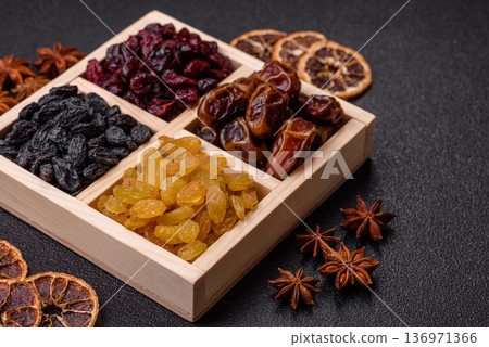 Dried fruits and berries, cranberries, dates, and raisins for a healthy diet. Dried berries and fruits Dried fruits and berries, cranberries, dates, and raisins for a healthy diet. Dried berries and fruits 136971366