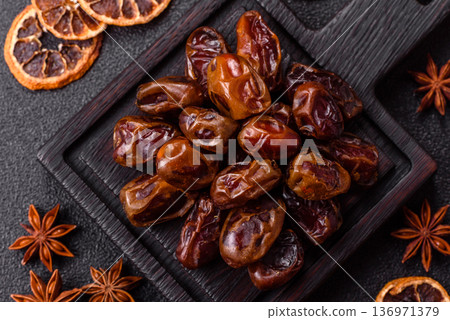 Dried sweet dates, natural tropical fruits for a healthy diet. Dried dates Dried sweet dates, natural tropical fruits for a healthy diet. Dried dates 136971379