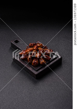 Dried sweet dates, natural tropical fruits for a healthy diet. Dried dates Dried sweet dates, natural tropical fruits for a healthy diet. Dried dates 136971389