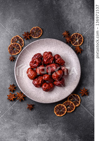 Red dried dates, the Chinese sweet fruit jujube, as a healthy food. Red dates, jujube Red dried dates, the Chinese sweet fruit jujube, as a healthy food. Red dates, jujube 136971537