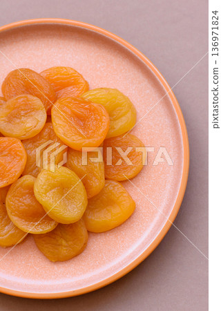 Dried apricots are a sweet, healthy fruit for vegans and vegetarians. Dried apricot Dried apricots are a sweet, healthy fruit for vegans and vegetarians. Dried apricot 136971824