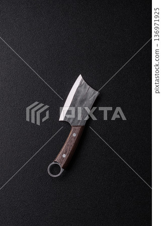A kitchen cleaver or butcher's knife for cutting meat. A butcher's cleaver 136971925