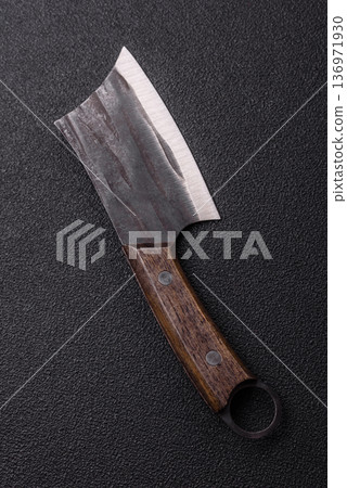 A kitchen cleaver or butcher's knife for cutting meat. A butcher's cleaver 136971930