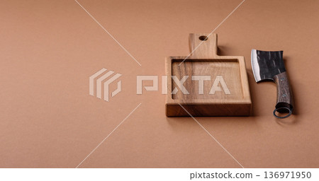 Empty wooden cutting board with a knife for food preparation. An empty wooden cutting board Empty wooden cutting board with a knife for food preparation. An empty wooden cutting board 136971950